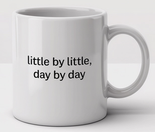 White ceramic coffee mug with minimalist black text that reads “little by little, day by day.” A motivational quote promoting steady progress and a positive mindset. Ideal for morning routines, growth quotes, and inspirational gift ideas by PhraseArtStudio.