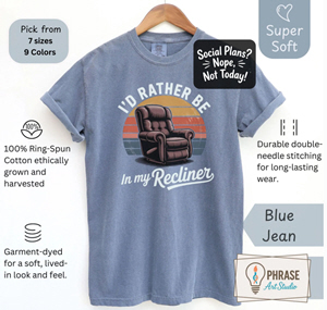 	Blue Jean aging humor shirt featuring a recliner illustration and the phrase “I’d rather be in my recliner.”