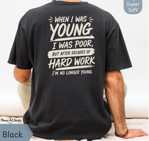 	Black shirt with white back lettering reading “When I was young I was poor, but after decades of hard work I am no longer young.”